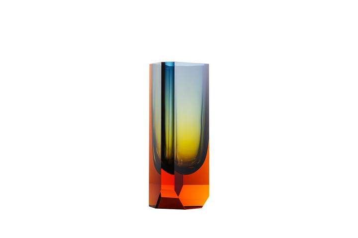 The Magnus vase is handmade using the technique of injected underlaying. This injection method gradually dissipates as the honey-brown topaz combined with blue creates yet a third colour: yellow-green. This effect is born as the colours and their changing intensities mutually overlap, making every vase completely unique. Monumental brutalism and delicate glasswork flow together in surprising harmony.