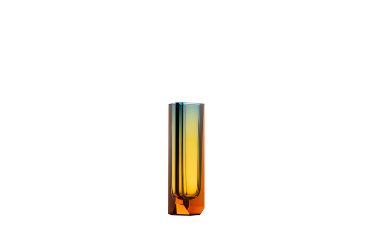 The Magnus vase is handmade using the technique of injected underlaying. This injection method gradually dissipates as the honey-brown topaz combined with blue creates yet a third colour: yellow-green. This effect is born as the colours and their changing intensities mutually overlap, making every vase completely unique. Monumental brutalism and delicate glasswork flow together in surprising harmony.