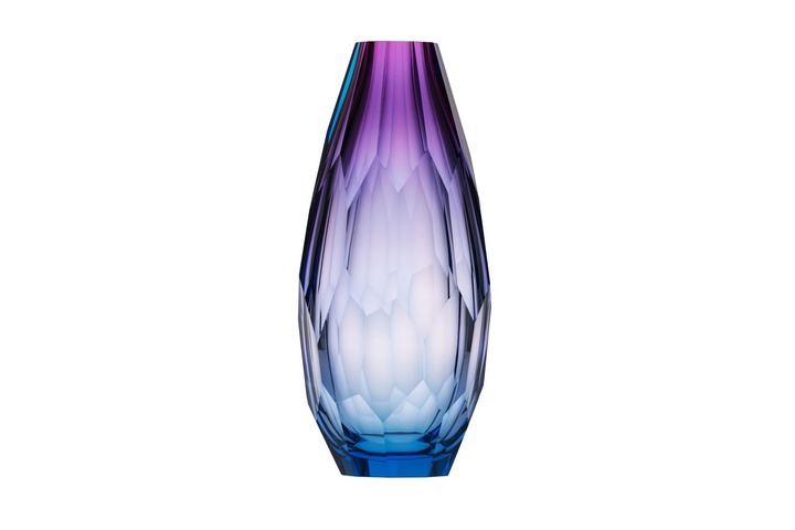 The richly blue base of the vase wanes through the misty azure into violet. A hand-cut vase, masterfully created without a template, to bring life to any space.